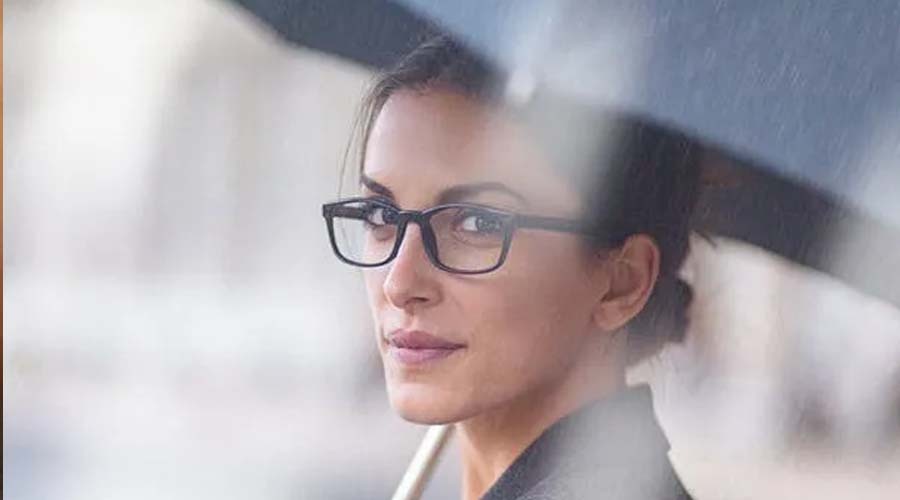 Lady in glasses under umbrella